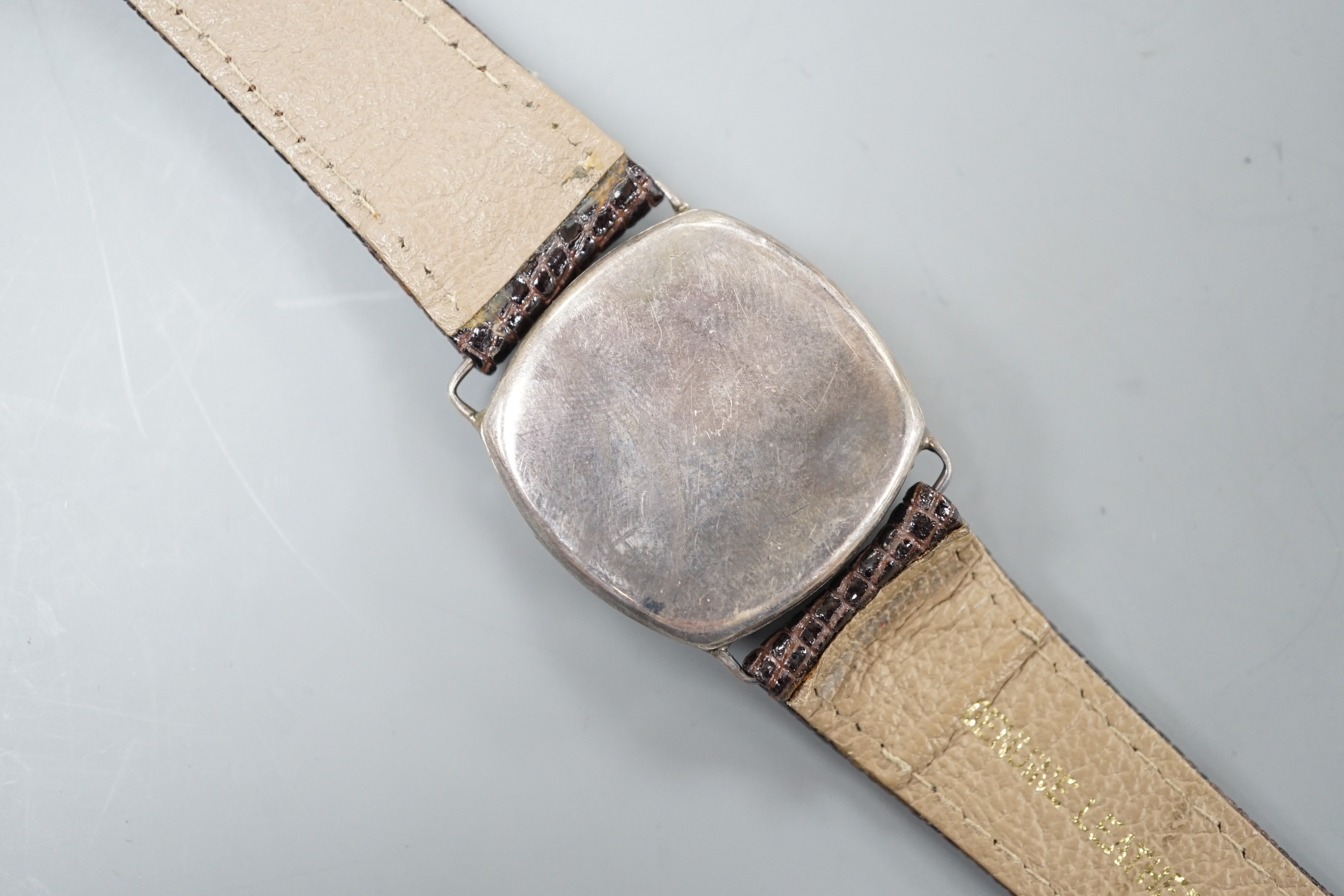 A gentleman's 1920's silver wrist watch, with Arabic dial and subsidiary seconds, the dial signed Rolex, movement unsigned, lacking winding crown.
